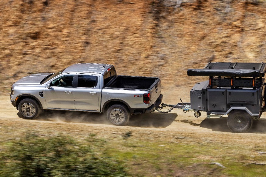 Silver Ford Ranger towing a trailer